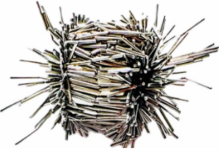 Different nails and chips attached to part due to grinding
